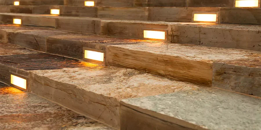 Stone steps illuminated with built-in lighting fixtures, providing safety and ambiance during nighttime.