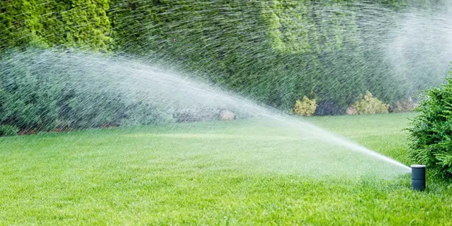 watering in a green lawn after repair sprinkler system